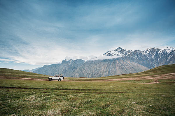 White SUV Car On Off Road In Spring Mountains Landscape. Drive A