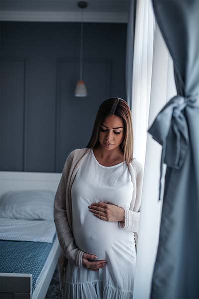 pregnant woman holding her belly