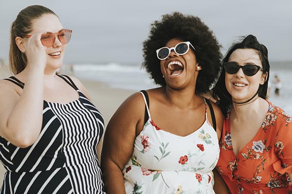 Cheerful diverse plus size women at the beach