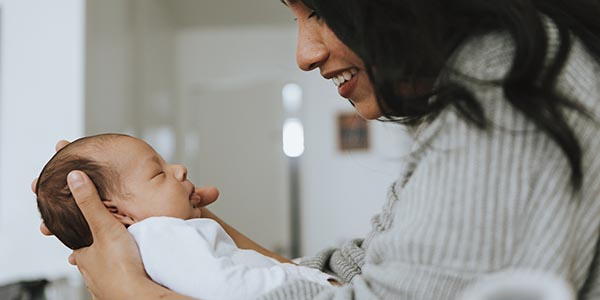 Mother holding her infant baby