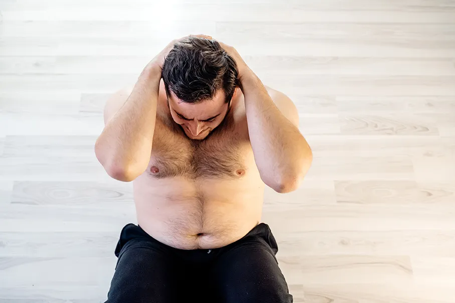 Overweight man preparing for weight loss surgery by exercising.